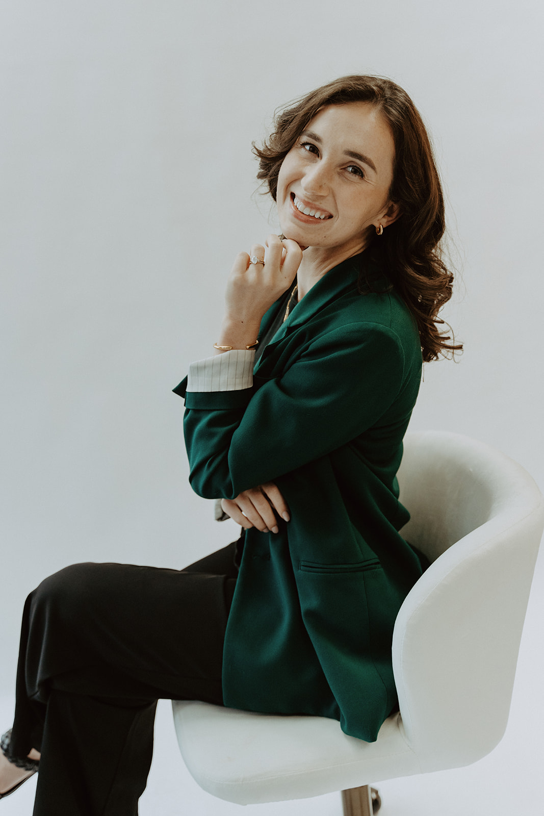 Jennifer of Emerald Aesthetics wearing a forest-green blazer.